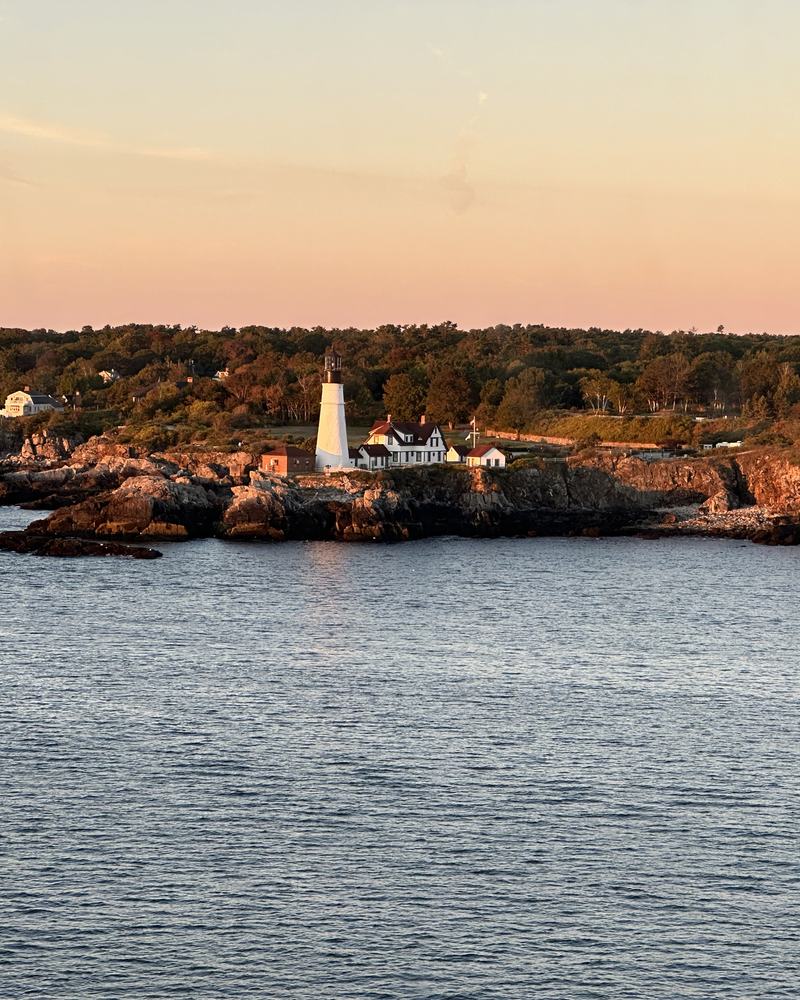 Lighthouse on a rocky headland at golden hour